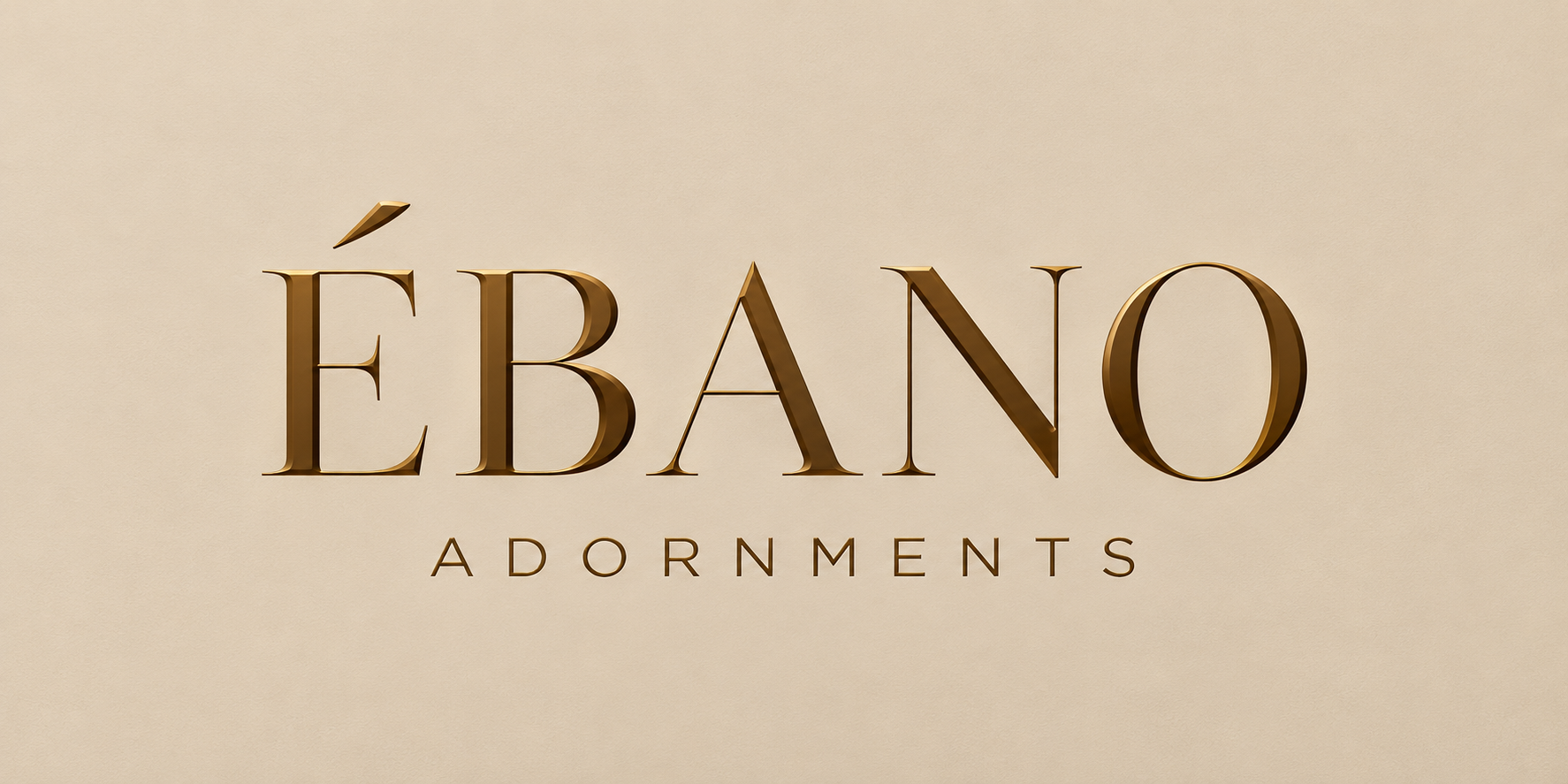 The original ÉBANO Adornments wordmark in embossed gold on textured beige